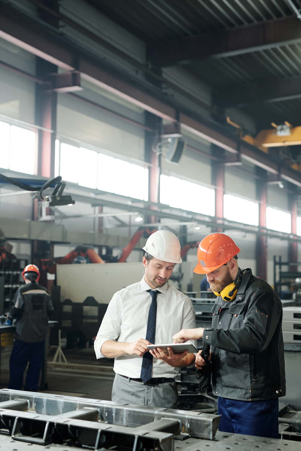 technician-formalwear-using-tablet-while-engineering-industrial-machine-with-factory-worker-workshop